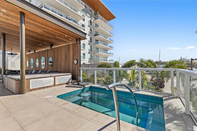 view of pool with an in ground hot tub