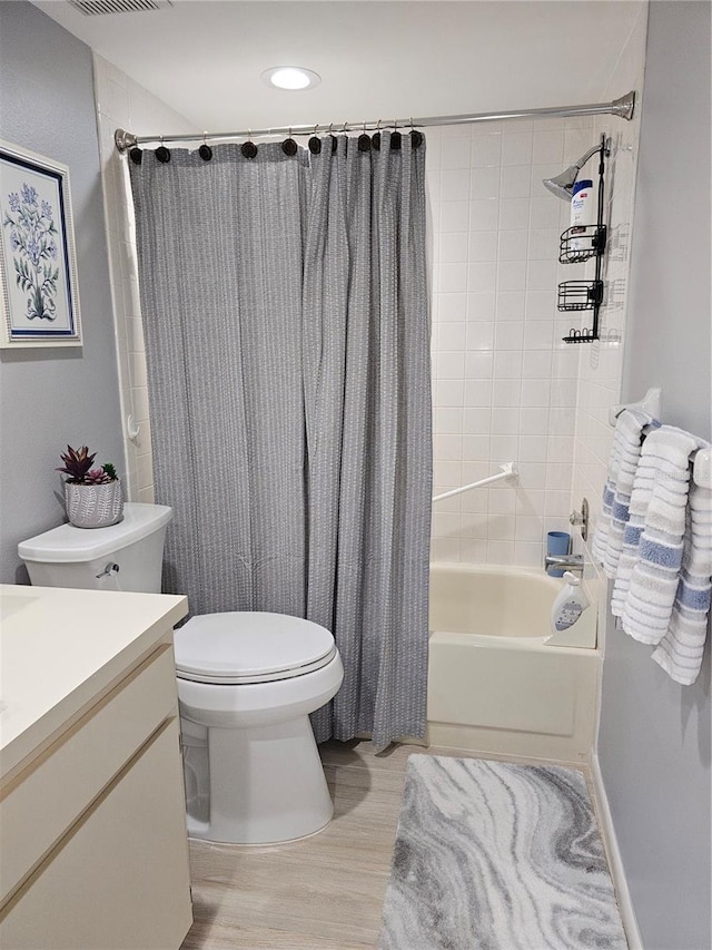 full bathroom with vanity, wood-type flooring, toilet, and shower / bath combo with shower curtain