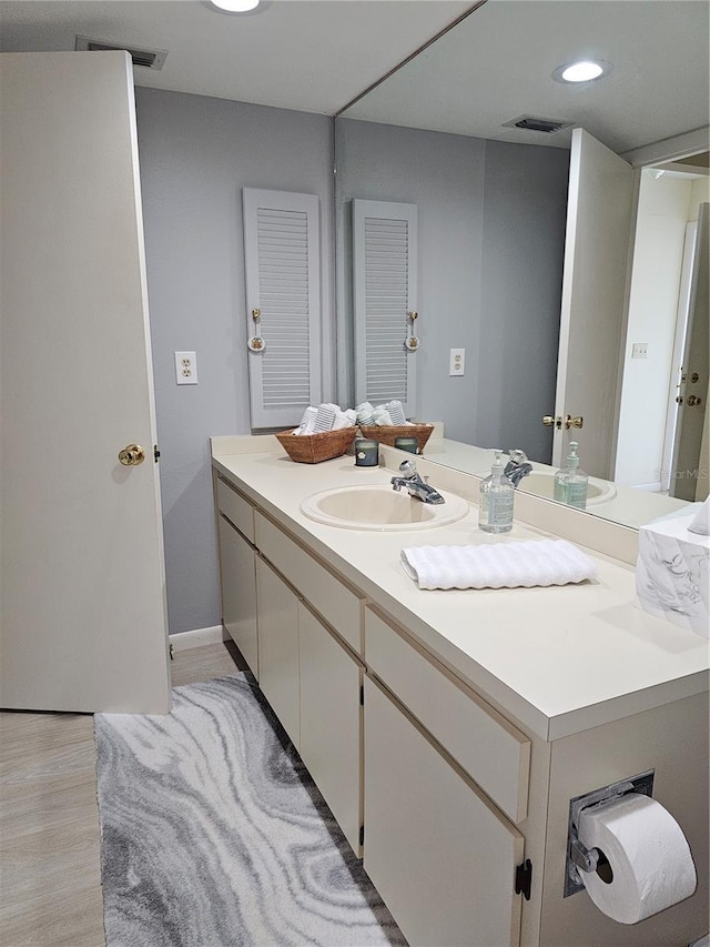 bathroom featuring vanity and hardwood / wood-style flooring