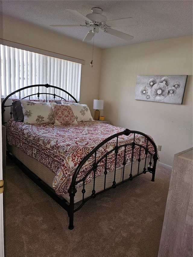 bedroom featuring ceiling fan, carpet, and a textured ceiling