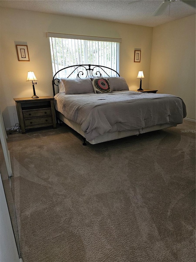 bedroom featuring carpet floors and a textured ceiling