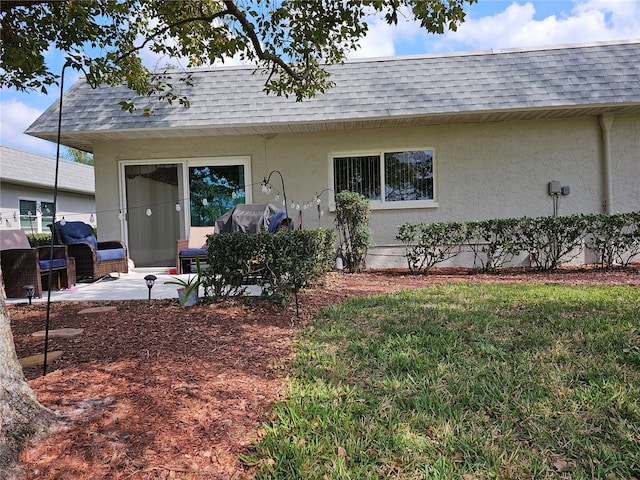 view of front of property with a patio area and a front yard