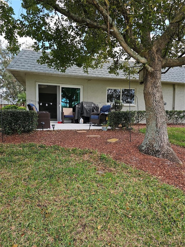 rear view of house with a lawn