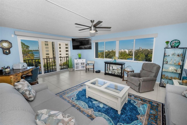 living room with tile patterned floors, a textured ceiling, and ceiling fan