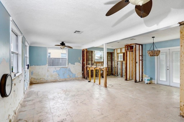 unfurnished room featuring a textured ceiling, french doors, and visible vents