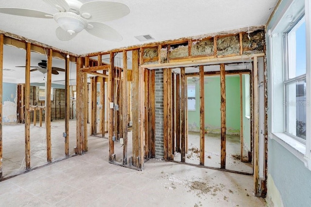 miscellaneous room featuring visible vents, a ceiling fan, and a wealth of natural light