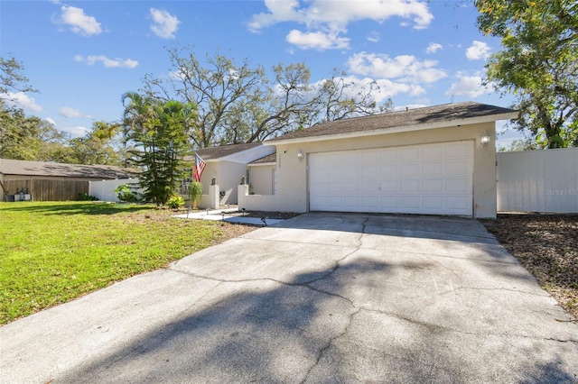 ranch-style house with a garage, fence, concrete driveway, stucco siding, and a front lawn