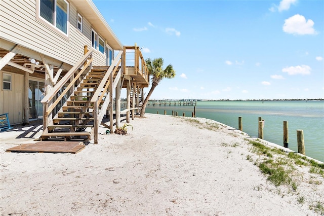 view of yard with a water view and stairs