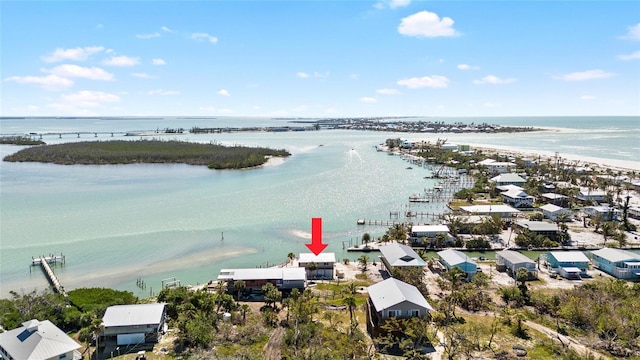 birds eye view of property with a water view and a view of the beach