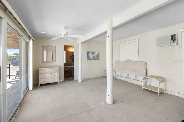 interior space with a ceiling fan, access to outside, a wall mounted air conditioner, and ensuite bathroom