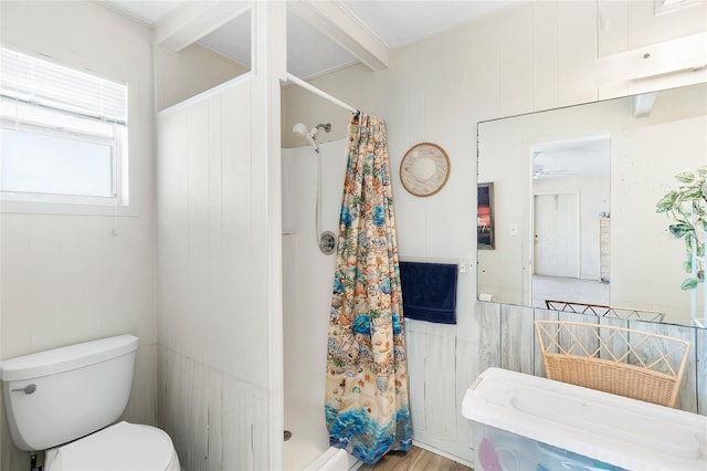 full bath featuring a shower stall and toilet