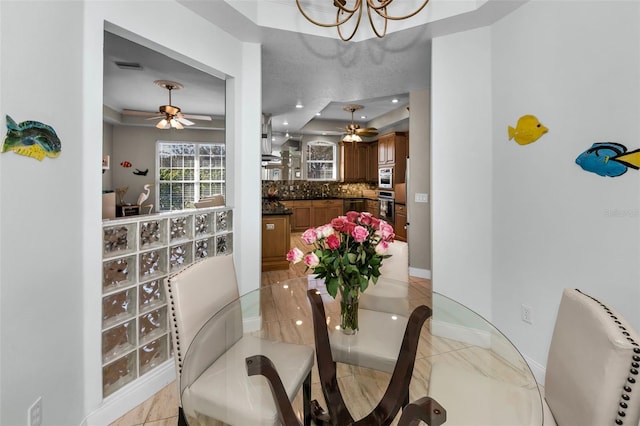 dining area featuring recessed lighting, visible vents, baseboards, and ceiling fan with notable chandelier