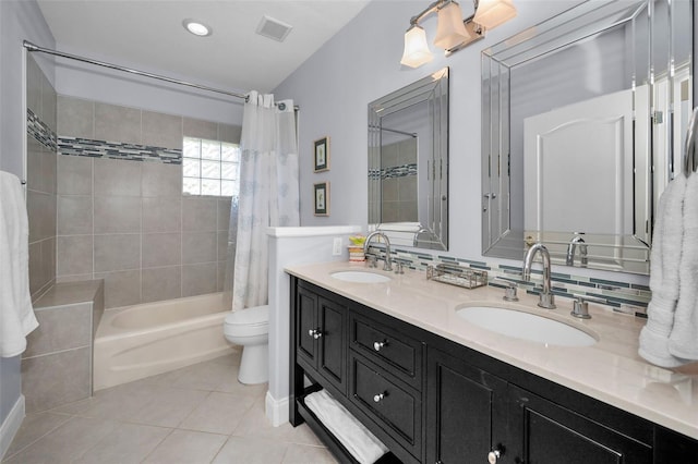 bathroom featuring shower / bath combination with curtain, tile patterned flooring, visible vents, and a sink