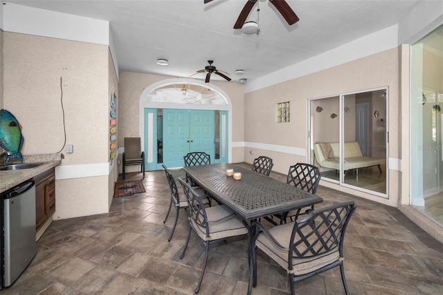 dining space with stone finish floor and ceiling fan