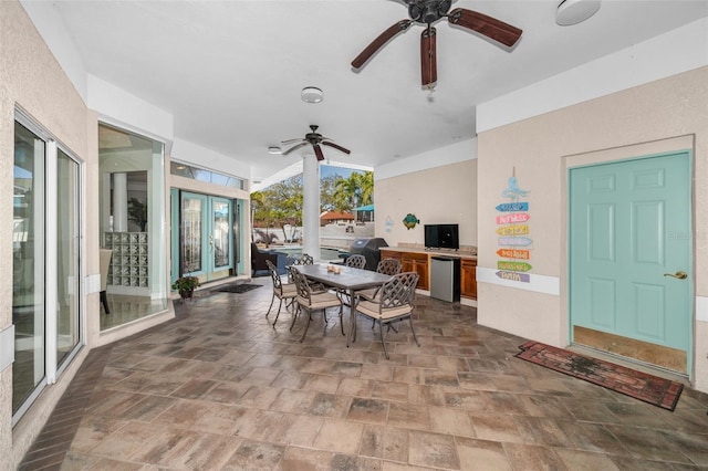 interior space with outdoor dining space, french doors, a ceiling fan, and area for grilling