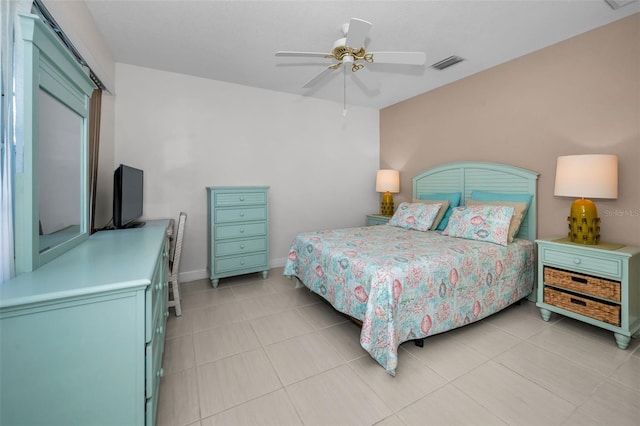 bedroom featuring ceiling fan, visible vents, baseboards, and light tile patterned flooring