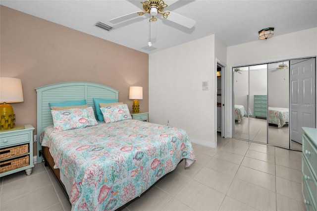 bedroom with ceiling fan, a closet, light tile patterned flooring, and visible vents