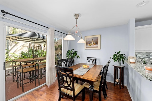 dining area with dark wood-type flooring