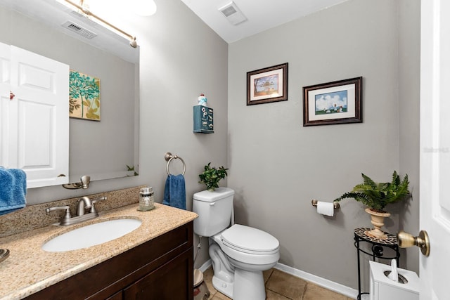 bathroom with tile patterned floors, vanity, and toilet