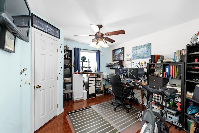 office with dark wood-type flooring and ceiling fan