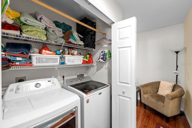 laundry area featuring separate washer and dryer and dark hardwood / wood-style floors