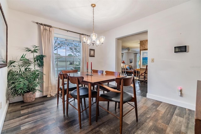 dining space featuring a ceiling fan, dark wood-style flooring, and baseboards