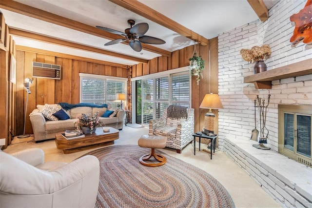 carpeted living room with a brick fireplace, wooden walls, an AC wall unit, and beamed ceiling