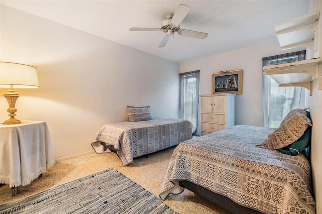 bedroom featuring ceiling fan, carpet, and baseboards