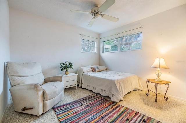 bedroom with ceiling fan, speckled floor, and a textured ceiling