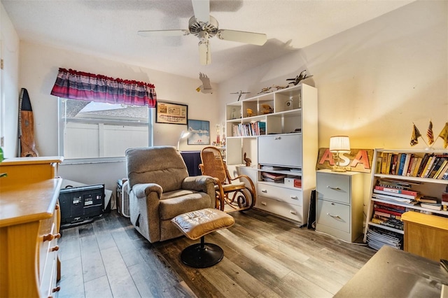 sitting room featuring ceiling fan and wood finished floors