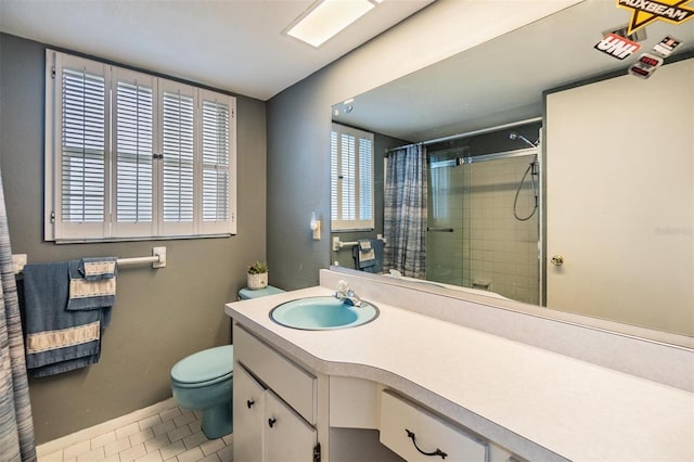 bathroom with toilet, vanity, baseboards, a tile shower, and tile patterned floors