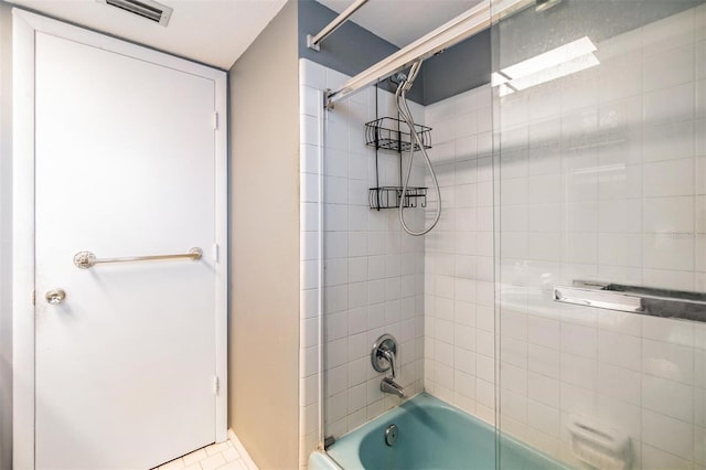 bathroom featuring shower / bath combination with glass door and visible vents