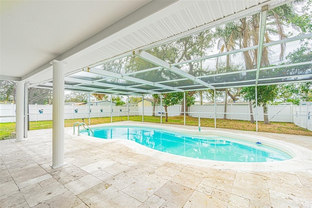 view of pool featuring a patio area and glass enclosure