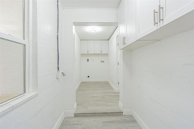 washroom with cabinets, hookup for an electric dryer, and light hardwood / wood-style floors