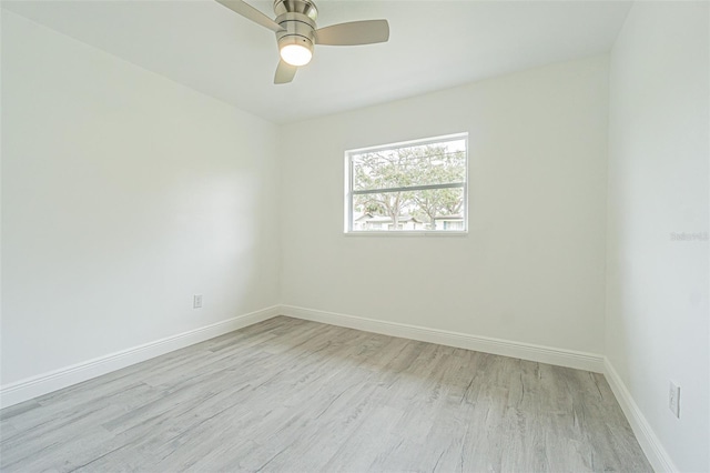 spare room with ceiling fan and light wood-type flooring