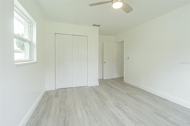 unfurnished bedroom with a closet, ceiling fan, and light hardwood / wood-style flooring