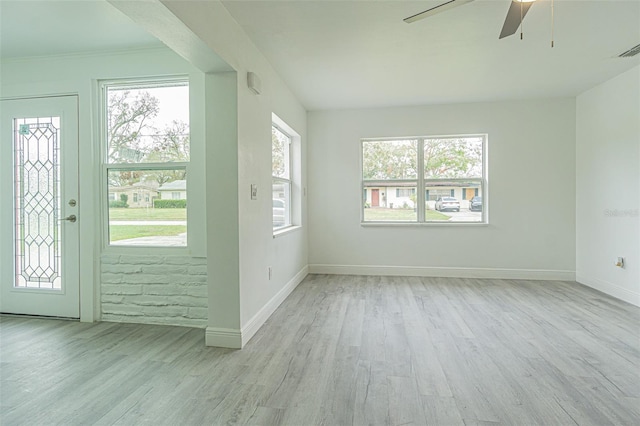 entryway featuring ceiling fan, a wealth of natural light, and light hardwood / wood-style floors