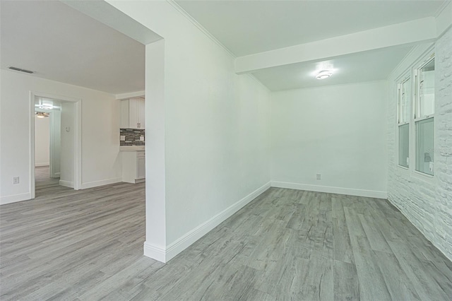 unfurnished room featuring ornamental molding and light hardwood / wood-style floors