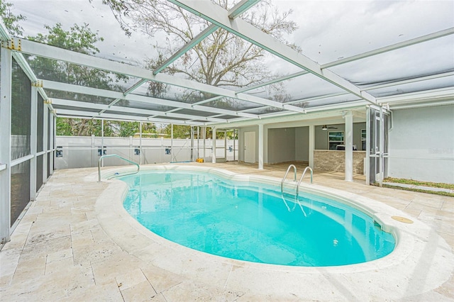 view of swimming pool featuring a lanai and a patio area