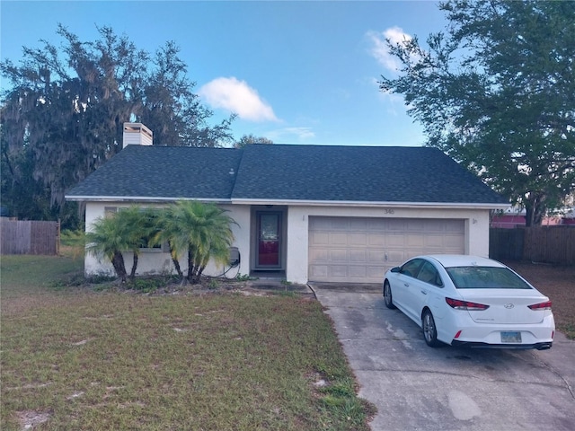 ranch-style house with a garage and a front yard