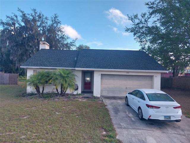 ranch-style house with a garage and a front lawn