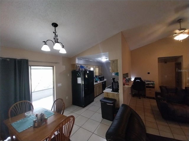 dining room featuring lofted ceiling, ceiling fan with notable chandelier, and light tile patterned floors