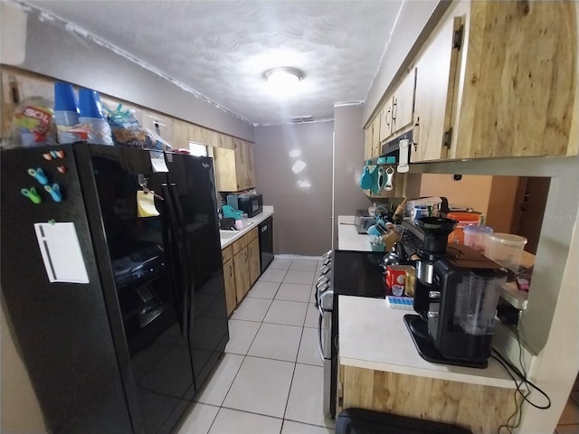 kitchen with light tile patterned floors and black appliances