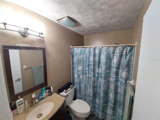 bathroom featuring toilet, vanity, and walk in shower