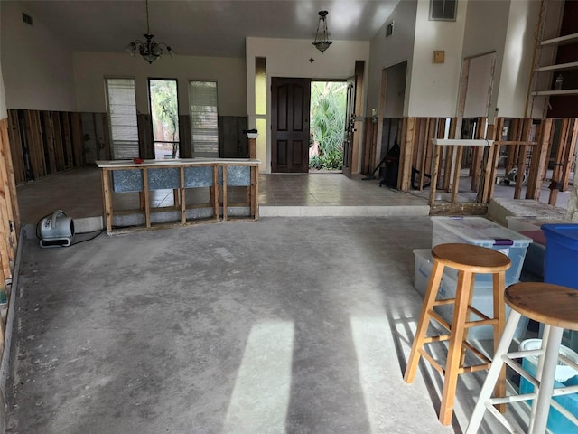 misc room with a wealth of natural light, concrete floors, and visible vents