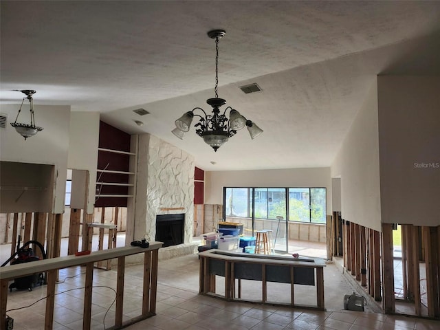 tiled living area with built in features, a fireplace, lofted ceiling, visible vents, and a chandelier