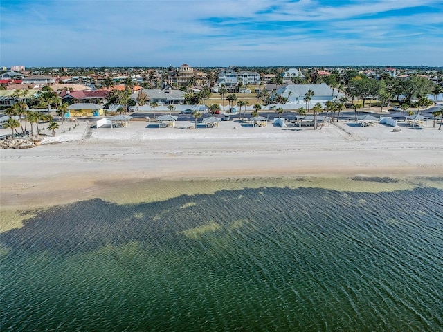 drone / aerial view featuring a water view and a view of the beach