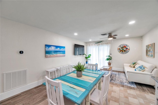 dining room with ceiling fan and light hardwood / wood-style flooring