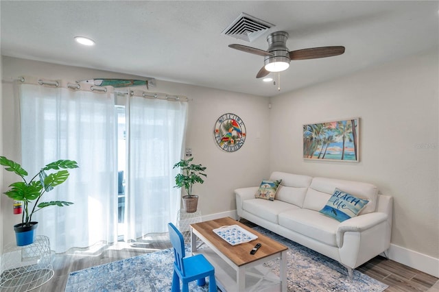 living room with hardwood / wood-style floors and ceiling fan