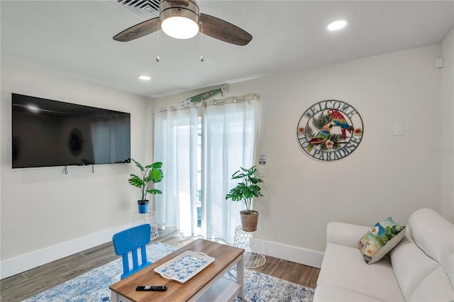 living room with ceiling fan, a healthy amount of sunlight, and hardwood / wood-style floors